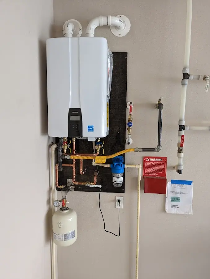 Professional plumber installing copper piping in a Tyngsborough home